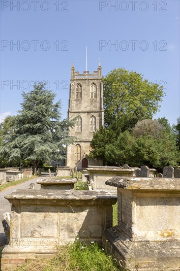 Tower of church of Saint Mary, Berkeley, Gloucestershire, England, UK chest tombs in graveyard