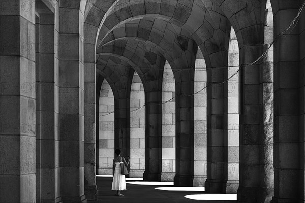 Lady in a white dress in the arcade of the Congress Hall, unfinished National Socialist monumental building on the Nazi Party Rally Grounds, Nuremberg, Middle Franconia, Bavaria, Germany, Europe