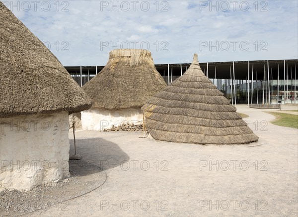 Reconstruction of neolithic homes thatched round houses huts, Stonehenge, Wiltshire, England, UK new visitor centre