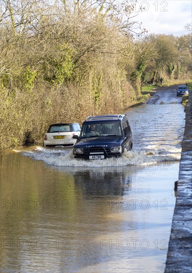 Land Rover Discovery Td5 vehicle driving through flood water at Kellaways, Wiltshire, England, UK 24/12/20