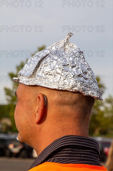 Self-deprecating aluminium hat wearer at a Monday demonstration against the corona measures in Bad Duerkheim under the motto Talking together, finding common ground