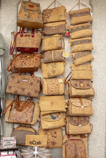 Close up of shop display of handbags made from cork oak souvenir products of butterflies and fish on sale, city of Evora, Alto Alentejo, Portugal, southern Europe, Europe