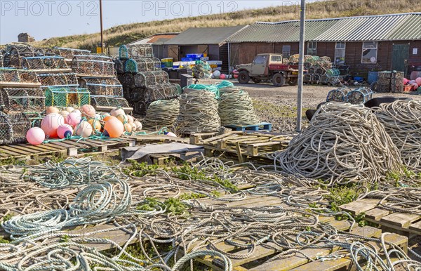 Fishing ropes, lobster pots and equipment on quayside Holy Island, Lindisfarne, Northumberland, England, UK