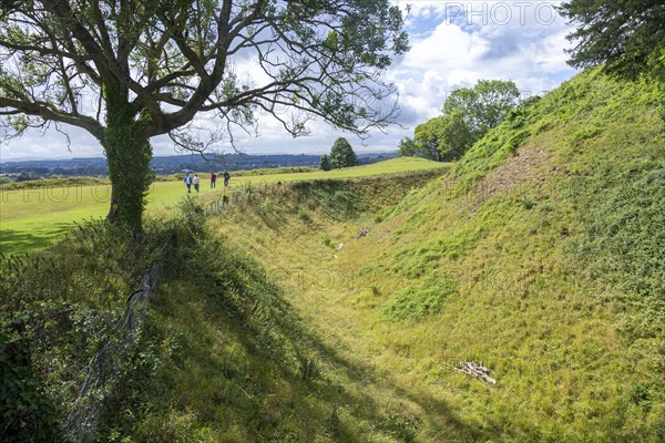 Deep defensive ditch and rampart at Old Sarum castle, Salisbury, Wiltshire, England, UK