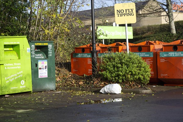 Rubbish bag dumped beneath No Fly Tipping sign, Sainsbury's recycling centre, Calne, England, United Kingdom, Europe