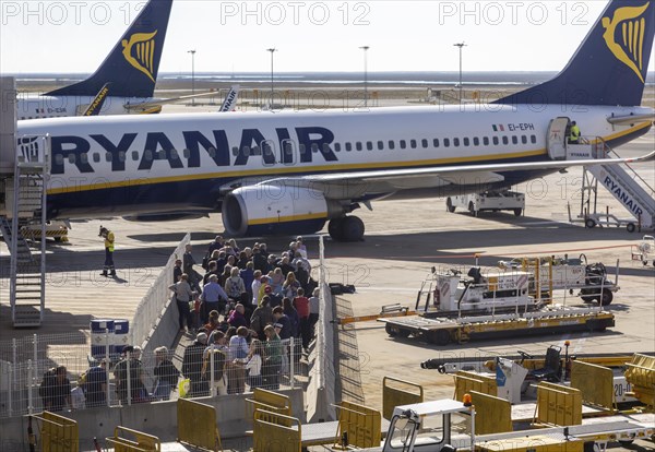 Passengers held back people waiting to board a Ryanair plane flight Faro airport, Portugal, Europe