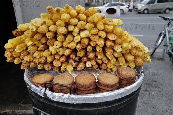 Reiberdatschi or fried potato pancakes beside fried potato slices at an outdoor stall on a cold winter's day. Vienna, Austria, Europe
