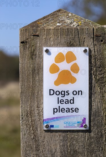 Macro close up of Dogs on Lead Please sign on fencepost, Sutton, Suffolk, England, UK