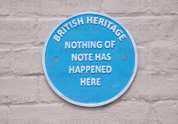 Humorous fake blue plaque sign on wall of house 'British Heritage Nothing of Note Has Happened Here'