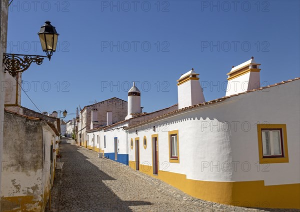 Traditional architecture with large chimneys in whitewashed houses and street in the small rural settlement village of Terena, Alentejo Central, Portugal, Southern Europe, Europe