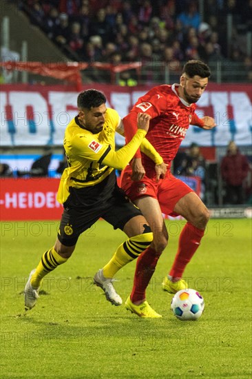 Football match, Emre CAN Borussia Dortmund in a duel with Tim KLEINDIENST 1.FC Heidenheim, football stadium Voith-Arena, Heidenheim