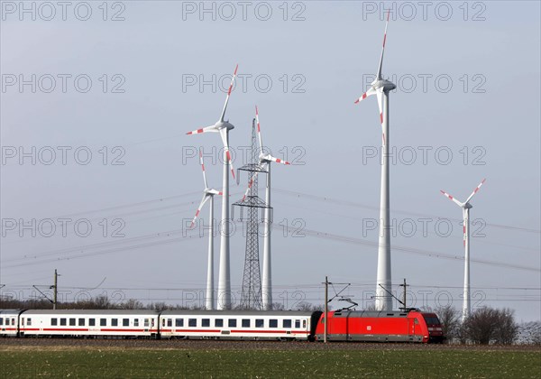 A Deutsche Bahn train passes a wind farm, Nauen, 03/03/2021