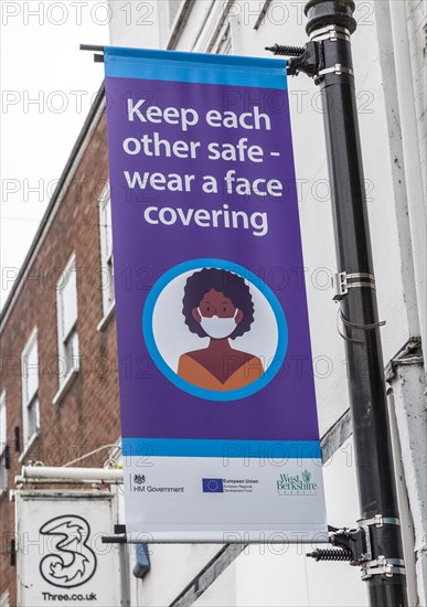 Keep each other safe wear a face covering Covid 19 information poster, Newbury, Berkshire, England, UK
