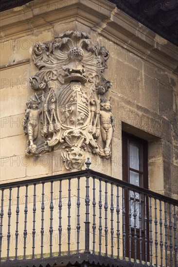 Stonework detail of coat of arms on wall of building, village of Elceigo, Alava, Basque Country, northern Spain