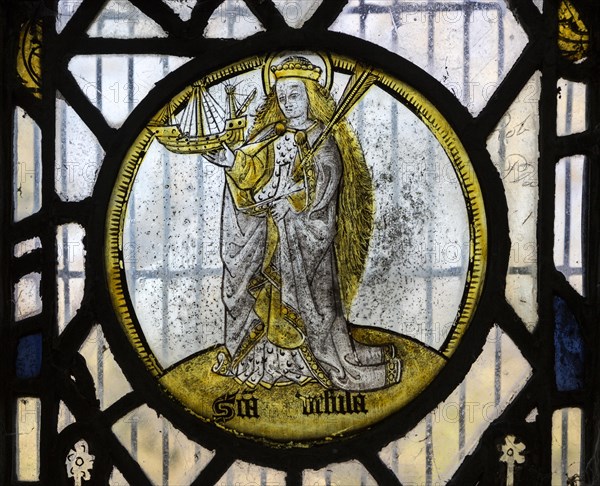 Saint Ursula medieval stained glass window roundel inside the church at South Elmham All Saints, Suffolk, England, UK