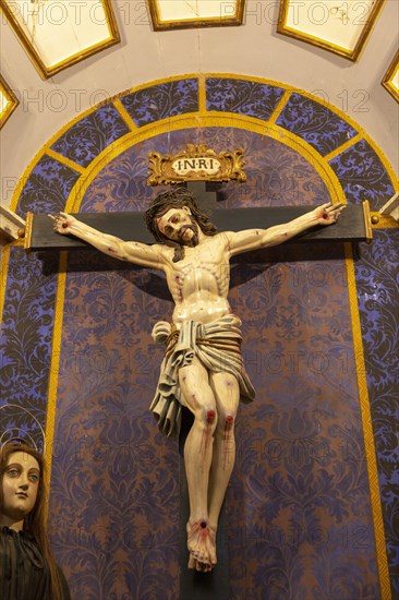 Ornately decorated Jesus Christ crucified on Cross church Igreja de Santiago, Tavira, Algarve, Portugal, Southern Europe, Europe