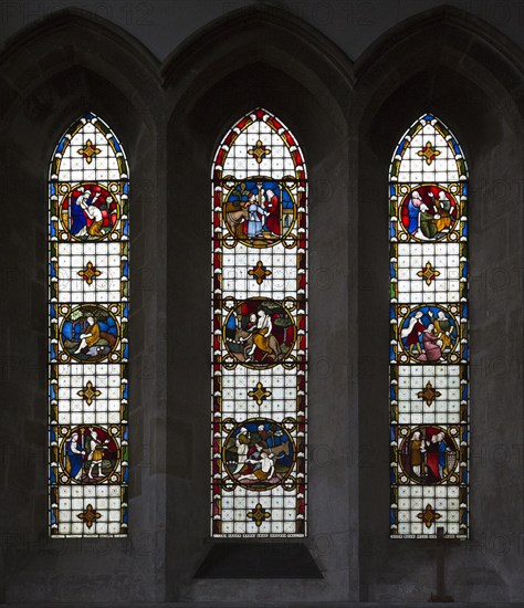 Stained glass in north transept window depicting biblical scenes by Clayton and Bell, undated, in church of Saint Mary, Potterne, Wiltshire, England, United Kingdom, Europe