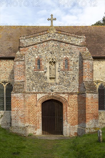 Stone statue of Saint Andrew porch of church of Ilketshall St Andrew, Suffolk, England, UK