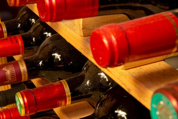 Wine cellar with red wine bottles (editorial)