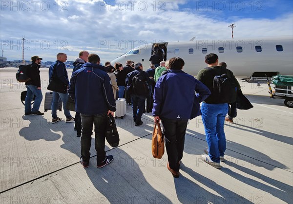 Passengers with hand luggage boarding a small aircraft on the tarmac, Duesseldorf Airport, North Rhine-Westphalia, Germany, Europe