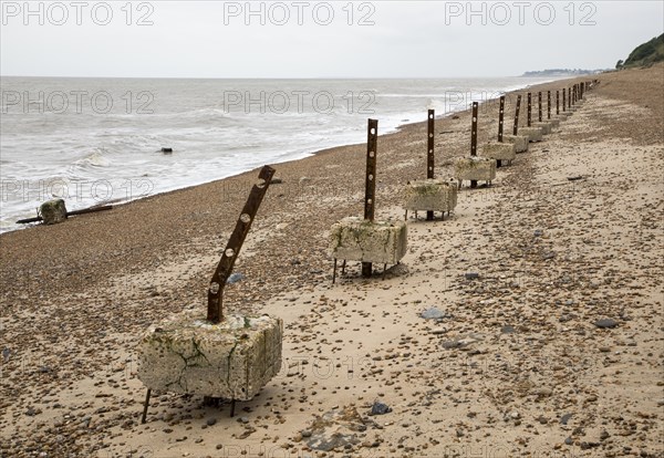 Remains of steel stanchions for barbed wire anti-invasion defences on beach at Bawdsey, Suffolk, England, UK