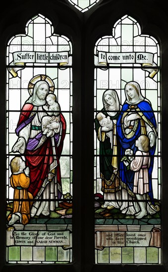 Stained glass windows in All Saints church, Lydiard Millicent, Wiltshire, England, UK