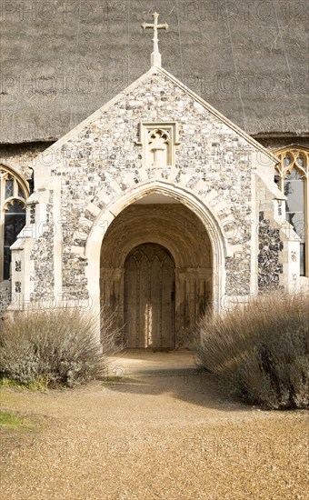 Entrance porch doorway village parish church and churchyard, Saint Mary, Henstead, Suffolk, England, UK