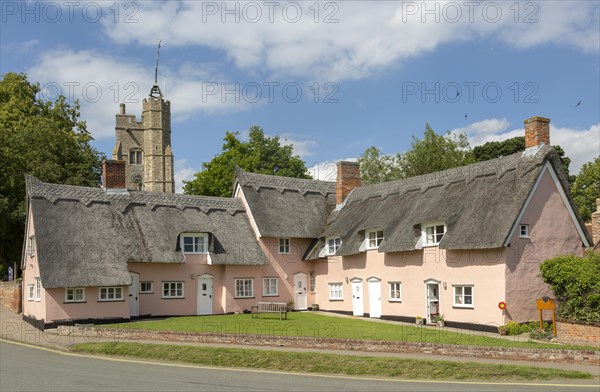Attractive pink thatched cottages and church village of Cavendish, Suffolk, England, UK, Hyde Park Corner