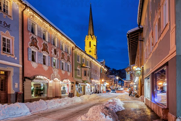 Snow-covered historic Ludwigstrasse in the Partenkirchen district with Christmas lights at dusk, Garmisch-Partenkirchen, Loisachtal, Werdenfelser Land, Upper Bavaria, Bavaria, Germany, Europe