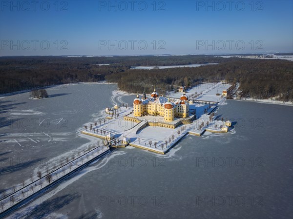 Moritzburg Castle on the castle island surrounded by the frozen castle pond, Moritzburg, Saxony, Germany, Europe