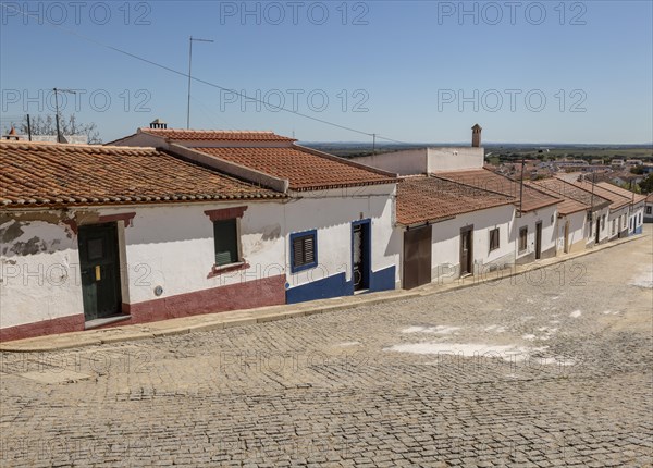 Traditional street of small Portuguese whitewashed cottage houses, Mourao, Alentejo Central, Evora district, Portugal, southern Europe, Europe