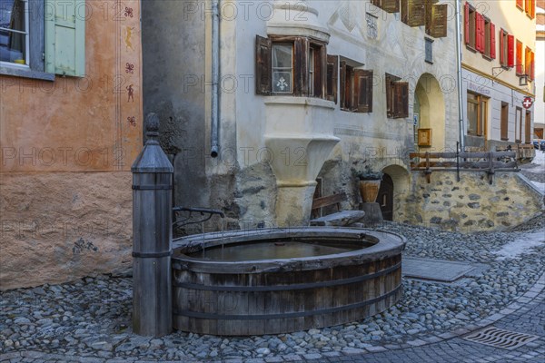 Wooden fountain, house with sgraffito, facade decorations, historic houses, Guarda, Engadin, Graubuenden, Switzerland, Europe