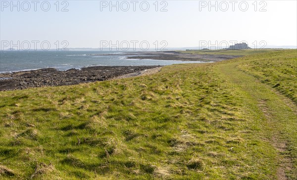 Coastline landscape scenery looking south towards Farne Islands and castle, Holy Island, Lindisfarne, Northumberland, England, UK