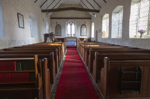 Interior of village parish church Saint Andrew, Covehithe, Suffolk, England, UK, stone carving baptismal font