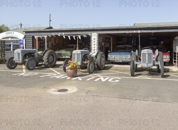 Old cars and Massey Ferguson tractors on display at Stonham Barns, Suffolk, England, UK