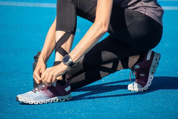 Young sportswoman wears running shoes from the Swiss shoe brand ON