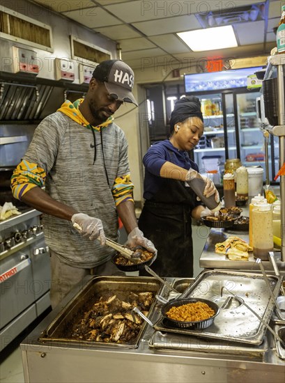 Detroit, Michigan, Workers prepare food at Yum Village restaurant, which serves Afro-Caribbean meals