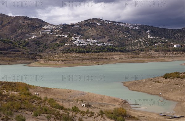Lake Vinuela reservoir at low water level view from Hotel La Vinuela, Axarquia, Andalusia, Spain rainclouds in sky