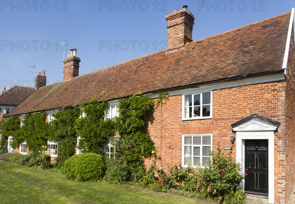 Row of red brick terraced cottages converted to one home, Orford, Suffolk, England, UK