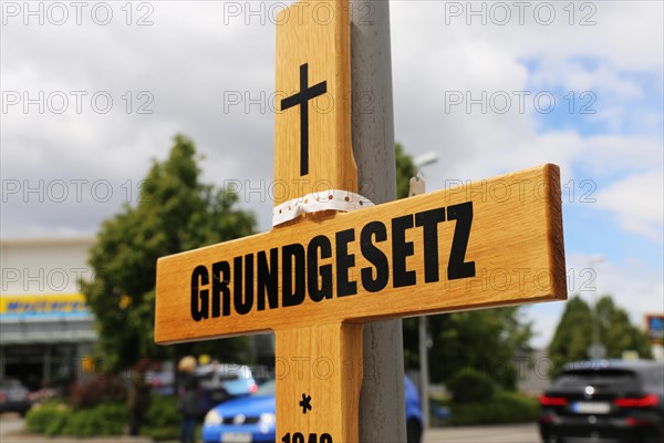 Symbolic grave cross with inscription on the Basic Law at a protest organised by critics of the corona measures in Ludwigshafen, Rhineland-Palatinate