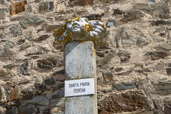 Ancient marble sculpture of Saint Mary, Santa Maria, aged with orange shield lichen resting one pedestal at the village of Terena, Alentejo Central, Portugal, Southern Europe, Europe
