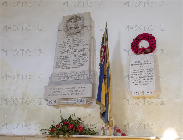 War memorial flag and poppy wreath inside the church at Tunstall, Suffolk, England, UK