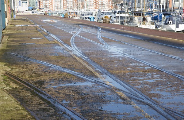 Old rail track lines on quayside Ipswich Wet Dock waterside redevelopment, Ipswich, Suffolk, England, Uk