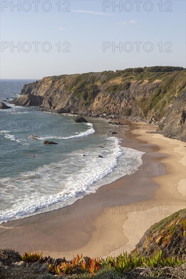 Secluded sandy beach in bay between rocky headlands at Parque Natural do Sudoeste Alentejano e Costa Vicentina, Natural Park, landscape view on the Ruta Vicentina long distance walking trail, at Praia dos Machados, Carvalhal, Alentejo Littoral, Portugal, southern Europe, Europe