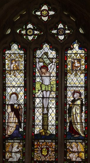 Stained glass window in church of Saint Mary Mary and Saint Lawrence, Stratford Tony, Wiltshire, England, UK by Kempe 1884 Crucifixion