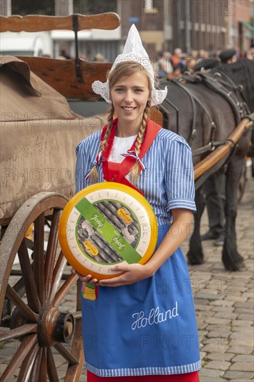 Pretty smiling girl in traditional Dutch costume, Gouda cheese market, South Holland, Netherlands