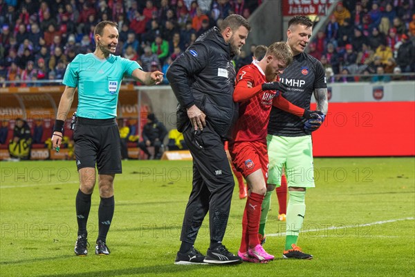 Football match, referee Bastian DANKERT shows physiotherapist Marc WEISS 1.FC Heidenheim left and goalkeeper Kevin MUeLLER 1.FC Heidenheim right together with the injured Jan-Niklas BESTE 1.FC Heidenheim the direction along the touchline, football stadium Voith-Arena, Heidenheim