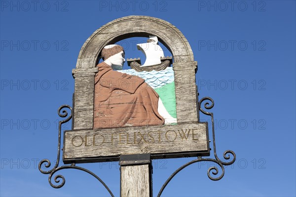 Village sign for Old Felixstowe depicting a monk and sailing ship, Felixstowe, Suffolk, England, UK