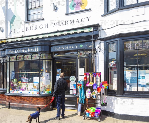 Aldeburgh pharmacy shop, Aldeburgh, Suffolk, England, UK traditional shop frontage and window display