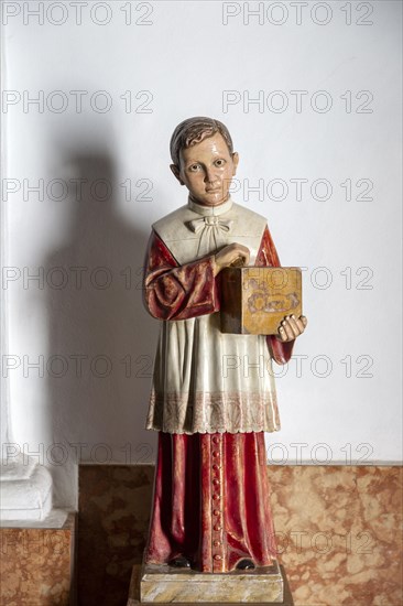 Model of young boy holding offertory collecting box at exit of church, Frigiliana, Malaga province, Spain, Europe